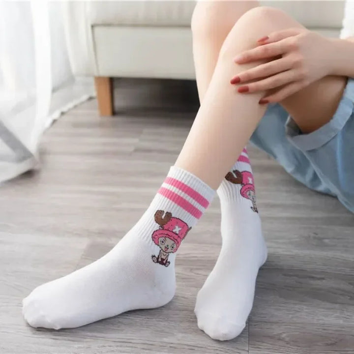 One Piece Chopper socks, white with embroidered design, folded neatly in a box with denim fabric backdrop.