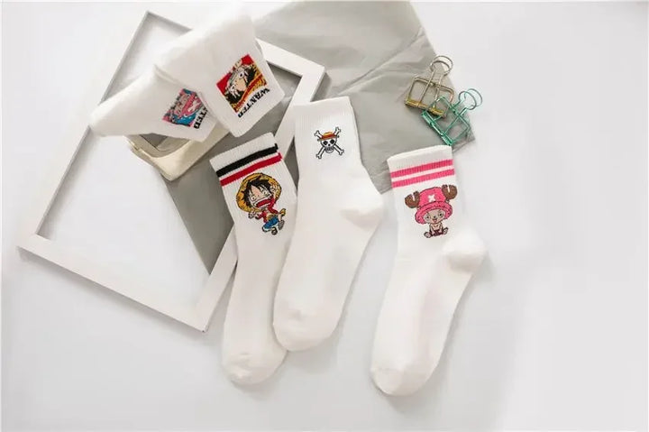 Luffy One Piece cartoon socks with wanted poster embroidery, white color, folded neatly in box on denim background