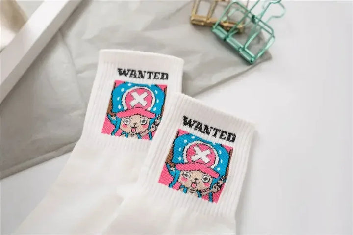 Cartoon character socks with Chopper from One Piece, white with wanted poster embroidery, placed on denim fabric in box